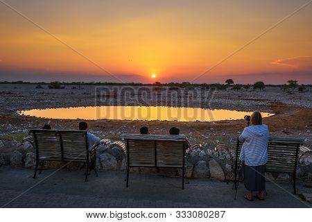 Okaukuejo, Namibia - April 3, 2019 : Tourists Wait For Wildlife At The Waterhole Of Okaukuejo Campsi