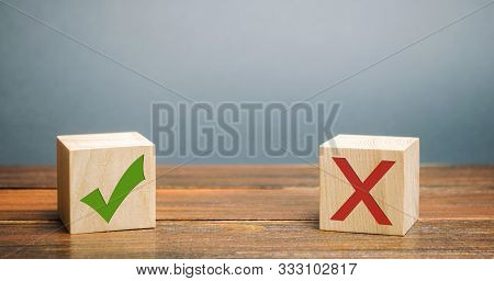 Wooden Blocks With A Green Check Mark And Red X. The Concept Of Choice And Making The Right Decision