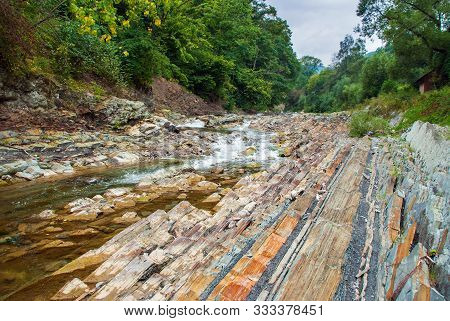 Mountain River Flowing Through The Green Forest