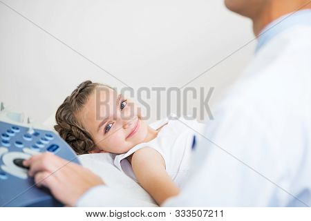 Doctor Ultrasound Examines Little Patient Belly At Hospital. Abdominal Cavity Diagnosis In Clinic Wi