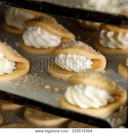 Finished Production Raw Sochniki Sochni With Cottage Cheese In Factory In The Steel Table. Tradition