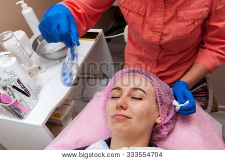 A Young Girl Is Lying On A Couch During Cosmetic Procedures With A Mask On The Face Above Which Beau