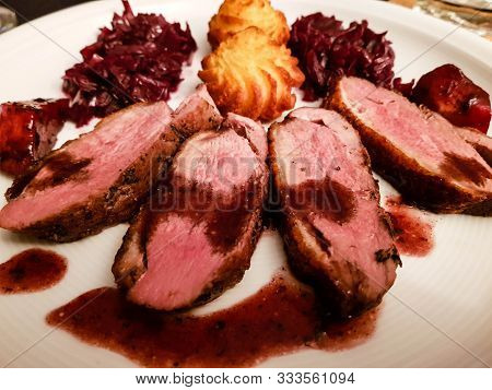 Fried Duck Breast With Red  Cabbage And Croquettes