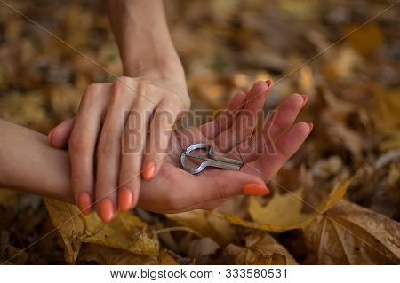 Female Hands Are Holding Traditional Hutsul Drymba Or Jews-harp, The Oldest Musician Instrument In T