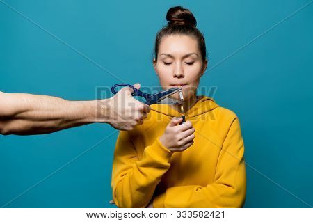 A Girl In Bright Clothes Is Going To Light A Cigarette, But A Male Hand With Scissors Is Going To St