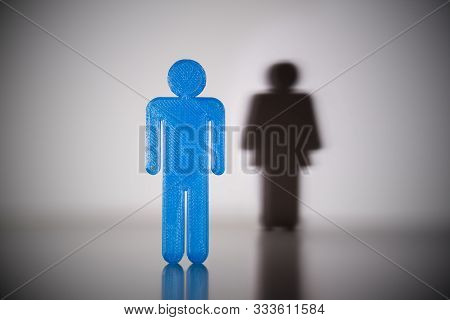 Blue Male Gender Human Figure With Shadow Of Female Gender Human Figure On Wall