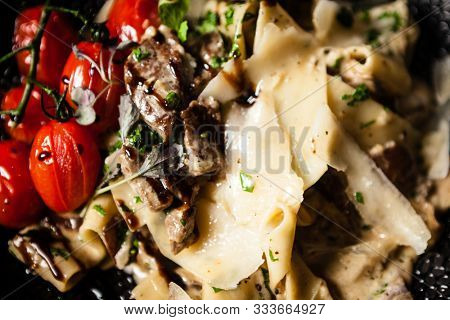 Black Angus pappardelle pasta with beef, champignon and parmegano cheese
