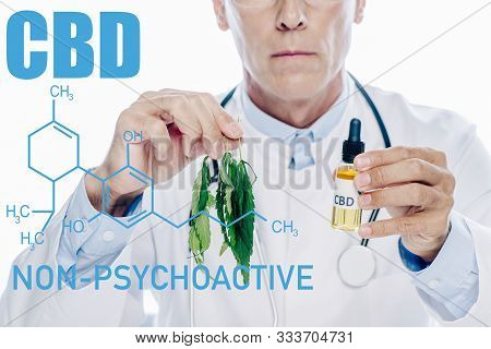 Cropped View Of Doctor In White Coat Holding Cbd Oil And Marijuana Leaf Isolated On White With Non-p