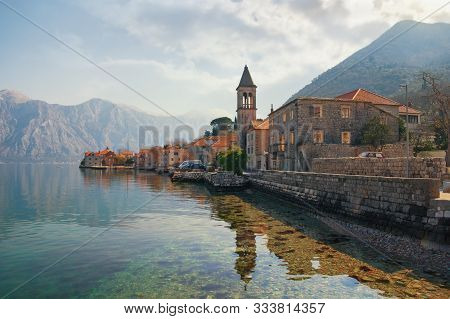 Beautiful Mediterranean Landscape. Small Seaside Village, Clouds And Mountains Are Reflected In Wate