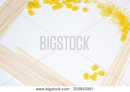 On A White Background On The Sides Are Different Pasta: Spaghetti, Vermicelli, Spirals