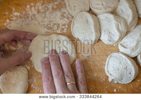 Woman Hands Preparing Slices Of Dough On A Wooden Board For Pies