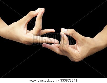 Pair Of Male Hands Isolated On Black Joined And Doing Pushan Mudra. Horizontal Shot.