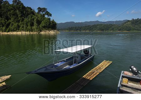 Fiber Speed Boat Floating Near The Boathouse.boat Is Main Transportation At Banding Lake Located In