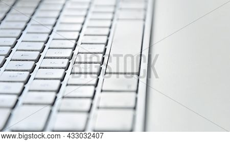 Detail Of A Modern White Computer Keyboard Dirty And Dusty On A White Table. Computer Hardware Devic