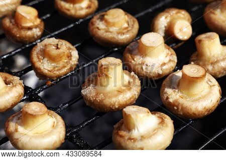 Close Up Common White Champignon Mushrooms Cooked On Bbq Char Grill Grate, High Angle View