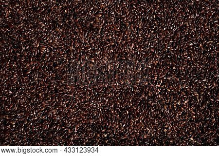 Toasted Flax Seeds. Full Screen Top View. Background