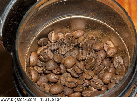 Natural Coffee Beans In Placers In Coffee Grinder Before Grinding