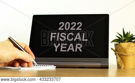 2022 Fiscal New Year Symbol. Tablet With Words 'fiscal Year'. Businessman Hand With Pen, House Plant