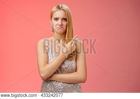 Jealous Displeased Angry Young Revengeful Blond Ex-girlfriend In Luxurious Silver Shiny Dress Frowni
