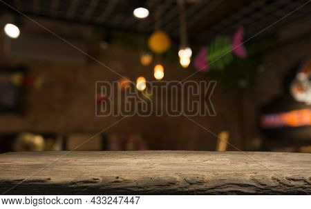 Image Of Wooden Table In Front Of Abstract Blurred Background Of Restaurant Lights
