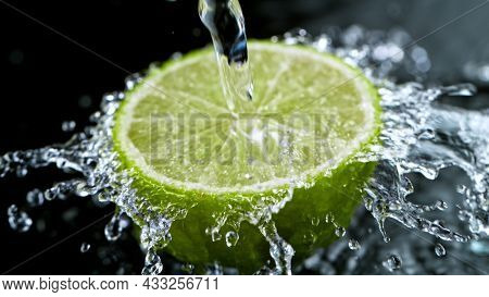 Freeze Motion Shot of Fresh Lime with Water Splash, close-up.
