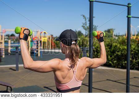 Sportive Woman Working Out On The Sports Ground In Sunny Summer Day