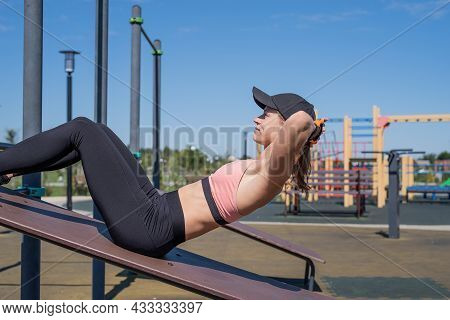 Sportive Woman Working Out On The Sports Ground In Sunny Summer Day