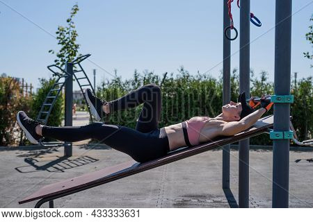 Sportive Woman Working Out On The Sports Ground In Sunny Summer Day