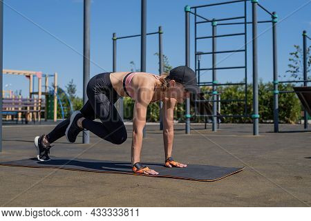 Sportive Woman Working Out On The Sports Ground In Sunny Summer Day