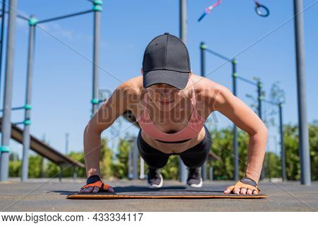 Sportive Woman Working Out On The Sports Ground In Sunny Summer Day