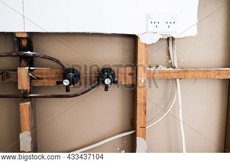 Laundry Room Renovation With Plaser Walls Interior Exposed With Visible Electricity Wires And Copper