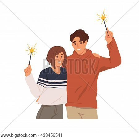 Happy Couple Of Man And Woman With Sparklers In Hands, Celebrate Christmas Holiday. People Holding F