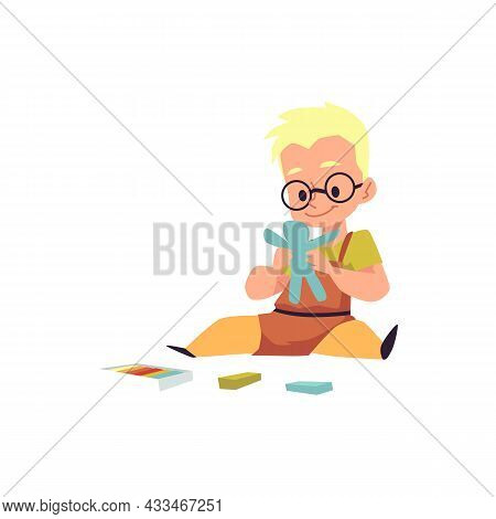Cute Kid Boy Sit On Floor And Making Human Figure From Blue Plasticine