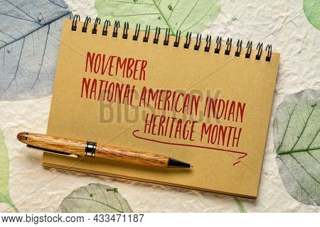 November - National American Indian Heritage Month, handwiting in a spiral notebook against handmade paper with leaf inclusions, reminder of historical and cultural event