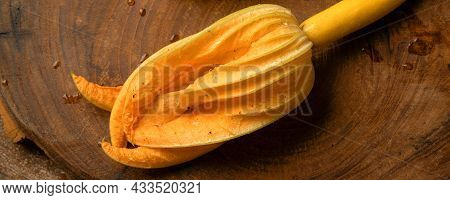 Zucchini Yellow Flowers On Solid Wood Cutting Board, Tree Bark On Rust Background.