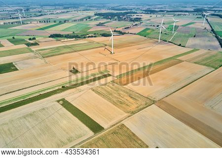 Windmill Among Agricultural Fields. Wind Turbine Generator At Summer Day. Wind Energy Concept. Suist