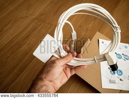 Paris, France - Aug 11, 2021: Personal Perspective Male Hand Holding New Wifi Dongle For Home-connec