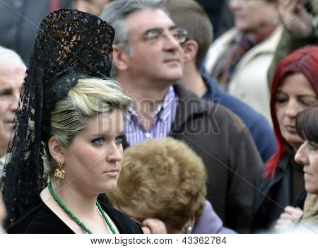 Female participant in Easter Procession, she carries the traditional head coverage called mantilla