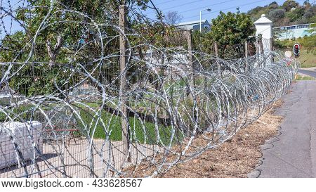 Razor Wire Installed On Factory Boundary Fence For Protection Of Manufactured Products From Theft Fr
