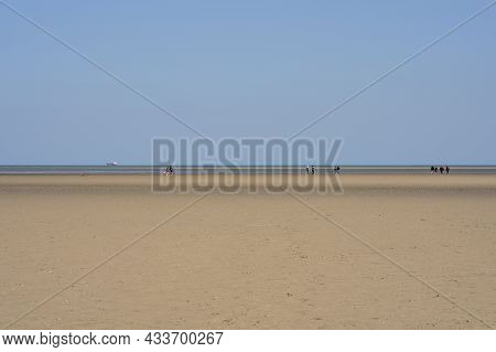 Dublin, Ireland - April 3, 2021: Beautiful Bright View Of Sandymount Beach, Walking People. Open Spa
