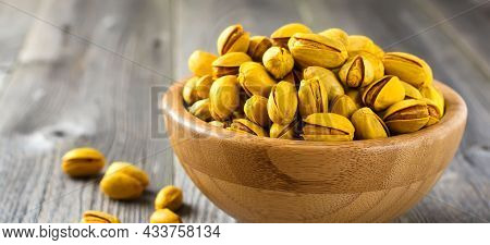 Salted Pistachios With Saffron In A Bamboo Plate. Selective Focus.