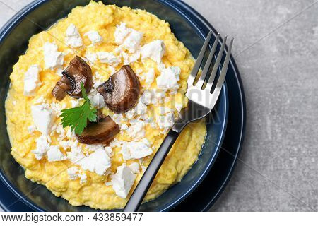 Tasty Banosh Served With Brynza And Mushrooms In Bowl On Grey Table, Top View. Traditional Ukrainian