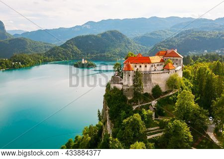 Aerial View Of Mediaeval Bled Castle On The Cliff Of The Mountain Under Lake Bled With Turquoise Blu