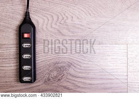 Black Usb Hub On A Wooden Background Close Up, Copy Space