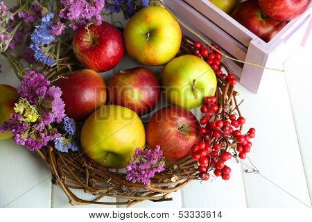Juicy apples in box on white wooden table