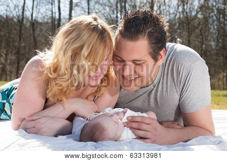 Young Parents And Their Baby