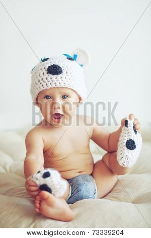 Portrait of a cute 1 year old baby dressed in a bear hat
