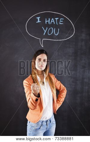 Woman next to a chalkboard with the words I hate you