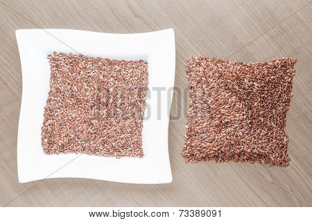 White ceramic bowl full of hemp seeds over old wood background