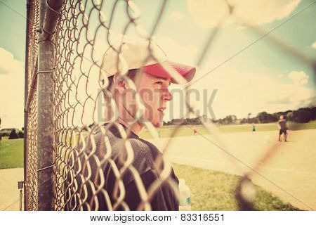 Teen boy on sidelines at baseball practice. Instagram effect.